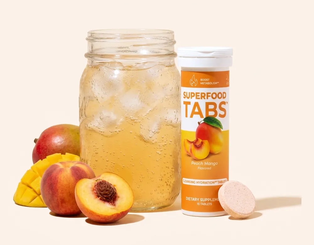 A mason jar of Peach Mango Superfood Tabs beside its tablet tube