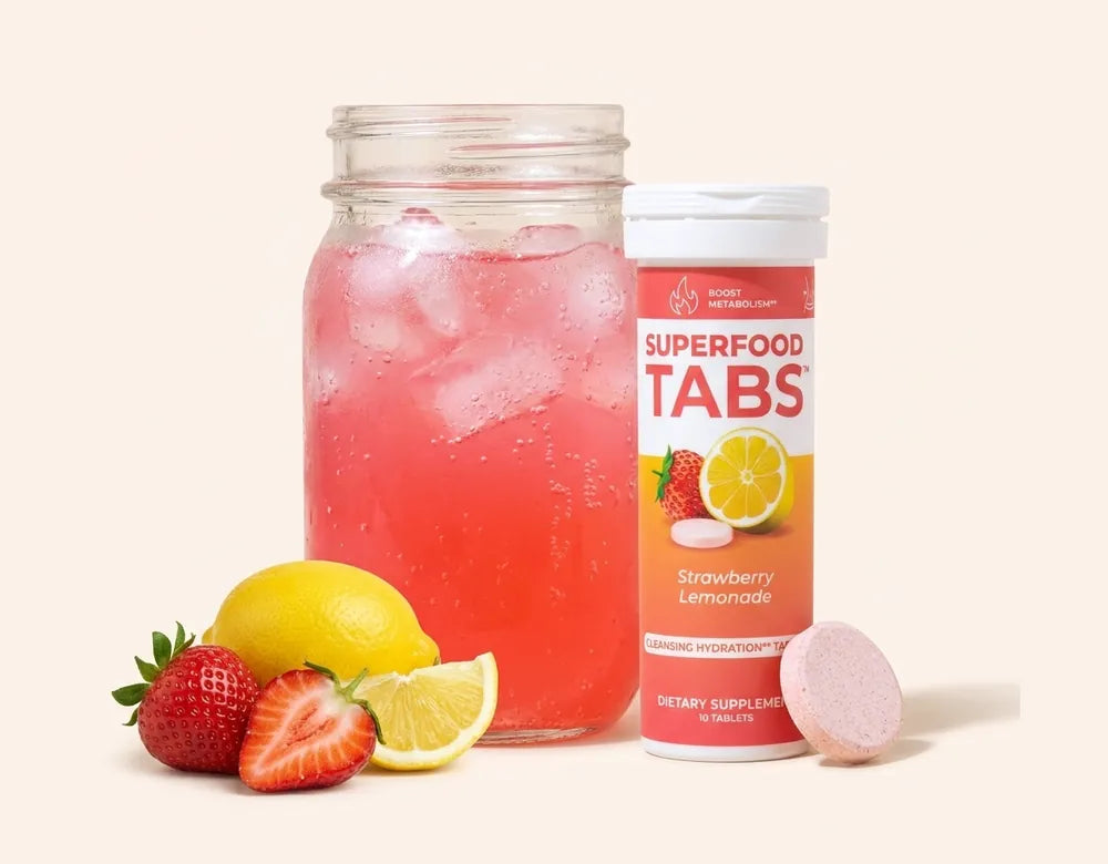 A mason jar of Strawberry Lemonade Superfood Tabs beside its tablet tube