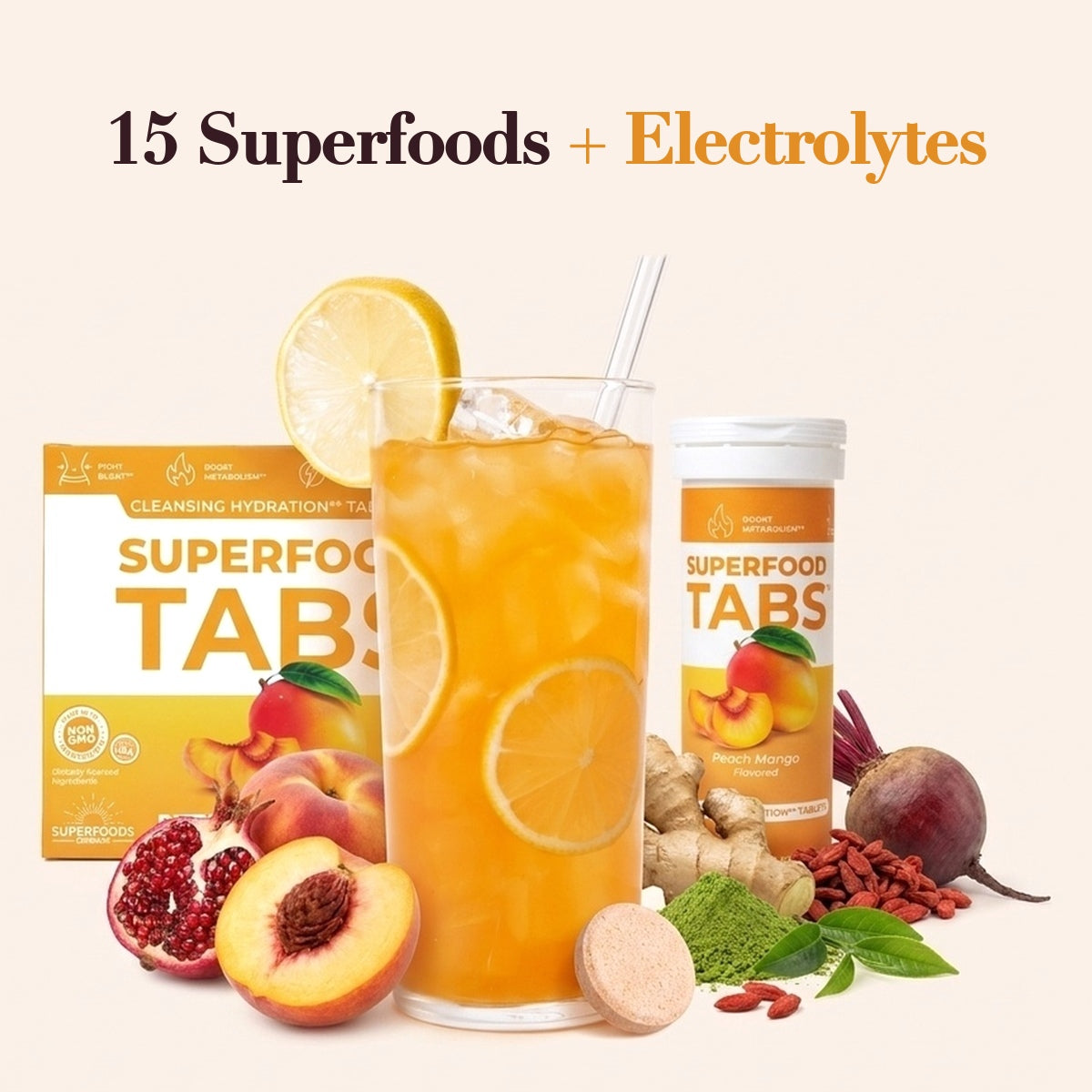 Superfood Tabs Peach Mango carton, tablet tube, a peach effervescent tablet and a tall glass of iced peach-mango drink, with peach, pomegranate, ginger, beet, goji berries, matcha and green tea leaves