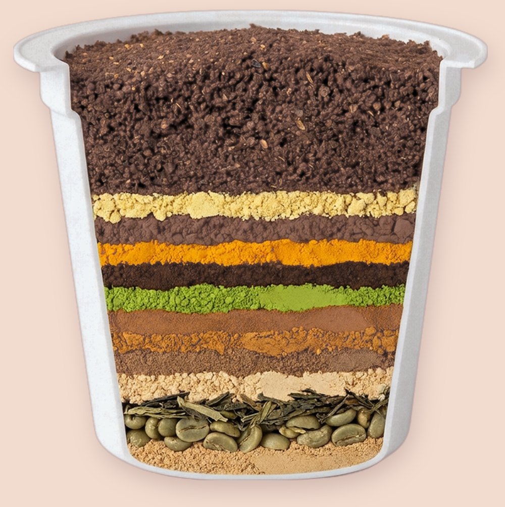 Amazing Coffee pod cut open, showing 12 layered superfoods above French Roast coffee