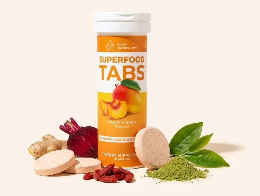 A Superfood Tabs Peach Mango tube with effervescent tablets, ginger root, beet, goji berries, matcha powder and green tea leaves
